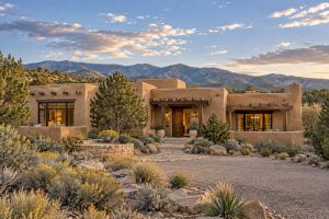 Luxury Pueblo Revival home with native landscaping in the Santa Fe foothills